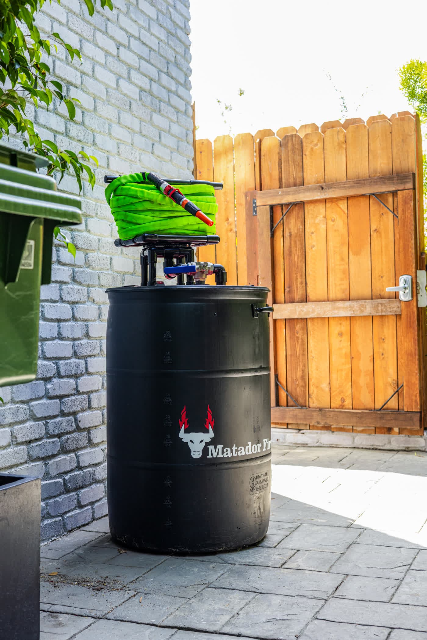 Matador Fire barrel, pump, and hose installed on a home patio