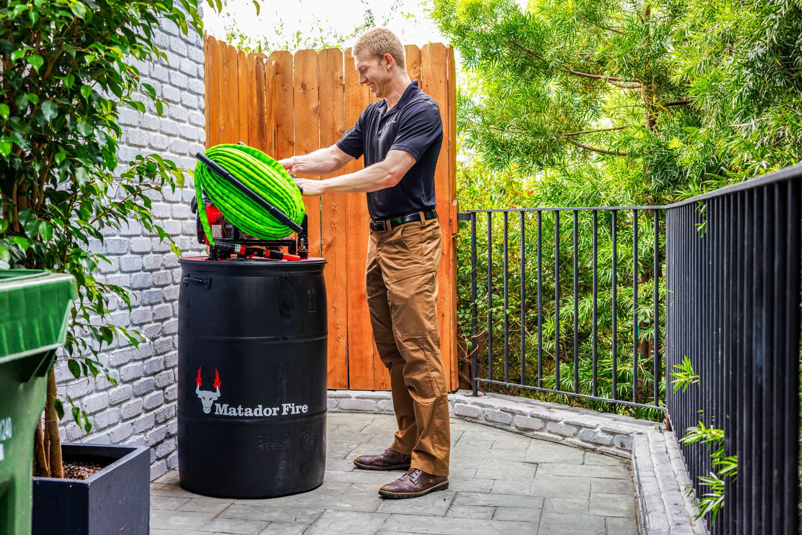Matador Fire Wildfire Defense System barrel and hose reel at a home