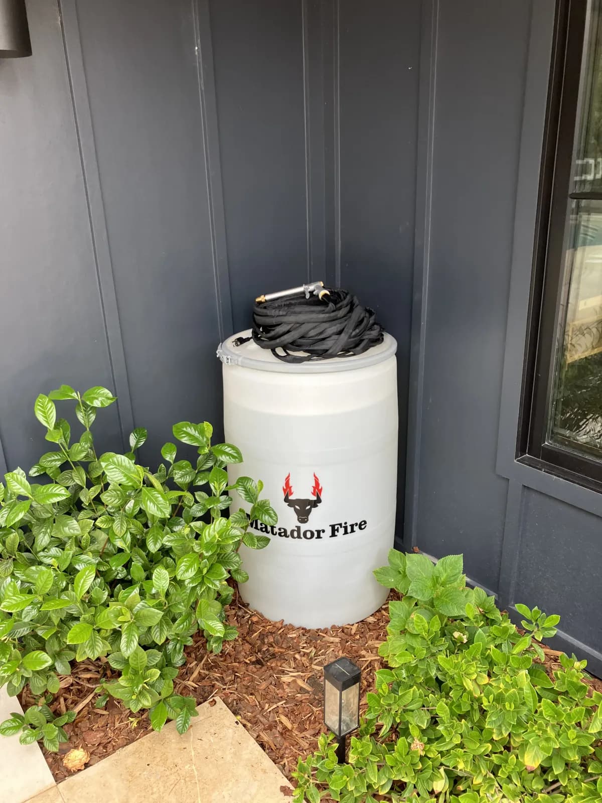 Matador Fire wildfire defense barrel installed at a residential property