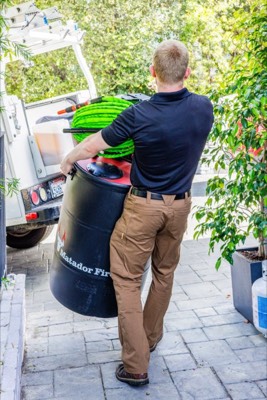 Matador Fire technician carrying a system