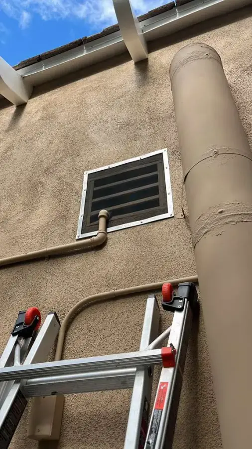 Ember-resistant mesh installed over foundation vent on a residential property